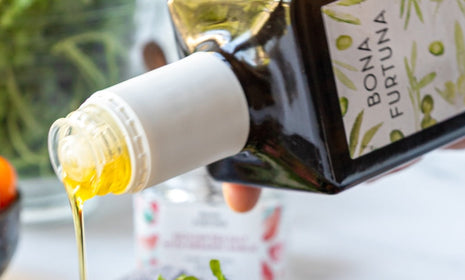 Polyphenol rich evoo pouring out of the bottle