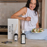 Women eating salad in kitchen - 6-month italian olive oil subscription