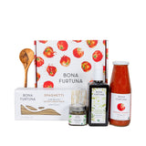 Bona Furtuna gift set featuring a box of spaghetti, a bottle of extra virgin olive oil, a bottle of tomato sauce, and a jar of honey, arranged in front of a decorative tomato-patterned gift box on a white background.