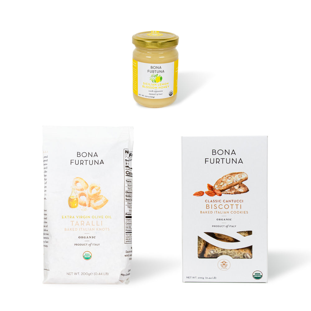 Bona Furtuna products including a organic honey jar, Taralli, and Biscotti on a white background - Buone Feste authentic italian food gift baskets